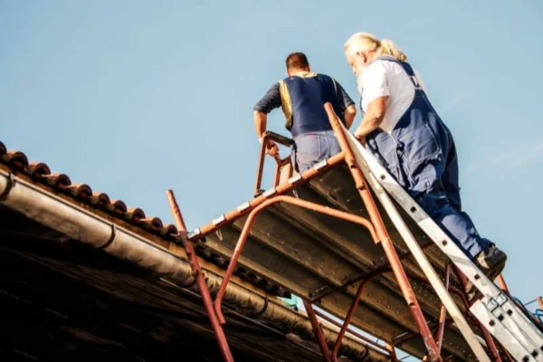An image about construction worker setting up scaffolding